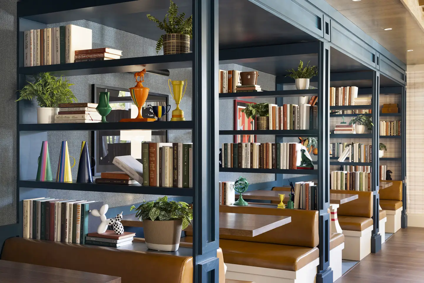 Study area with booths that are separated by bookshelves.
